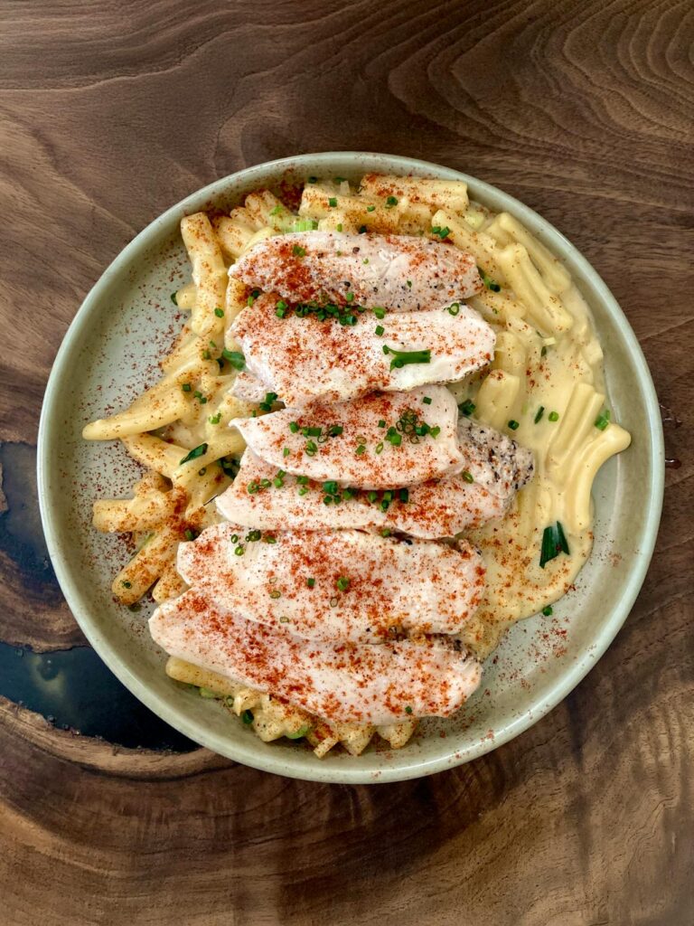 A plate of creamy chicken linguine well seasoned and beautifully presented.