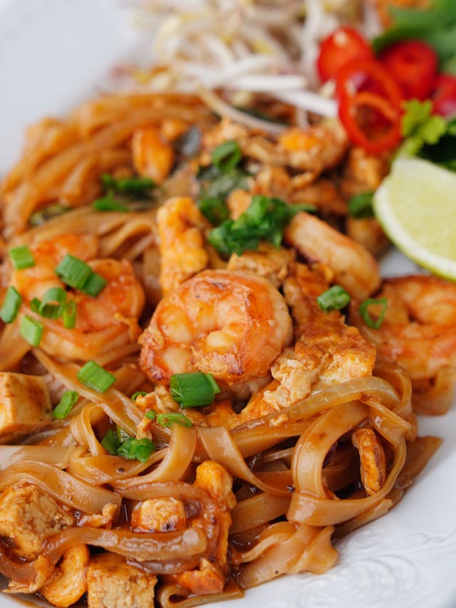 A close-up look on a plate of creamy garlic butter shrimp pasta
